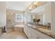 Bathroom featuring double sinks, a glass shower, jacuzzi tub and granite countertops at 1217 Bamboo Dr, Charleston, SC 29407