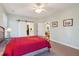 Bedroom featuring a ceiling fan and sliding barn doors to the ensuite bathroom at 1217 Bamboo Dr, Charleston, SC 29407