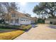 Exterior of home with a well-manicured lawn, attached garage, and outbuilding at 1217 Bamboo Dr, Charleston, SC 29407