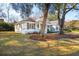 Charming single-story home boasts mature trees, a welcoming front porch, and beautiful landscaping at 1217 Bamboo Dr, Charleston, SC 29407
