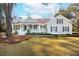 Charming single-story home boasts a welcoming front porch, a well-manicured lawn, and beautiful landscaping at 1217 Bamboo Dr, Charleston, SC 29407