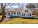 Charming single-story house featuring a covered front porch, traditional windows, and a well-manicured lawn at 1217 Bamboo Dr, Charleston, SC 29407