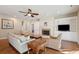 Open living room with fireplace, natural light, and hardwood floors at 1217 Bamboo Dr, Charleston, SC 29407