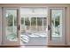 Access to screened porch, featuring sliding doors and views of the backyard and grill at 1217 Bamboo Dr, Charleston, SC 29407