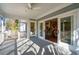 Screened porch with views into living area, kitchen, and outdoor deck area at 1217 Bamboo Dr, Charleston, SC 29407
