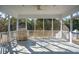 Relaxing screened porch with ceiling fan, grill, and shaded views of the backyard at 1217 Bamboo Dr, Charleston, SC 29407