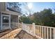 View from the wooden deck with white railing leading up to the screened in porch at 1217 Bamboo Dr, Charleston, SC 29407