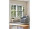 Sitting area in main bedroom with a large window, and cozy chair with wood floors at 1217 Bamboo Dr, Charleston, SC 29407