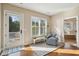 Sitting area in main bedroom with deck access, large windows, and an ensuite bath at 1217 Bamboo Dr, Charleston, SC 29407