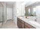 Bathroom featuring double sinks with granite counters, a glass shower, tile floors, and white panel doors at 123 Lakelyn Rd, Moncks Corner, SC 29461
