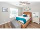 Bedroom with wicker bed frame, a wooden floor, a gray bench, and natural light from a window at 123 Lakelyn Rd, Moncks Corner, SC 29461