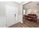 Bright foyer with decorative door, adjacent dining area, and wood flooring at 123 Lakelyn Rd, Moncks Corner, SC 29461