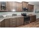 A kitchen with stainless steel appliances, gray cabinets, and granite countertops at 123 Lakelyn Rd, Moncks Corner, SC 29461