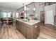 Kitchen featuring a granite island with a stainless steel sink, pendant lights, and hardwood floors at 123 Lakelyn Rd, Moncks Corner, SC 29461