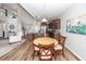 A kitchen and dining area with hardwood floors, stainless steel appliances, and gray cabinets at 123 Lakelyn Rd, Moncks Corner, SC 29461