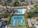 Aerial view showcasing community amenities: pool, tennis courts, playground, surrounding homes, and waterway at 1249 Waterfront Dr, Mount Pleasant, SC 29464