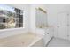 Bathroom with a large tub, double vanity, and a view of the outdoors at 1249 Waterfront Dr, Mount Pleasant, SC 29464