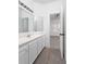 Bathroom with a large mirror, white cabinets, and access to another room at 1249 Waterfront Dr, Mount Pleasant, SC 29464