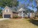 Beautiful brick home with a well-maintained lawn, arched entry detail, and lovely landscaping at 1249 Waterfront Dr, Mount Pleasant, SC 29464