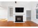 Living room with hardwood floors, a fireplace, built-in shelves, and a neutral color palette at 1249 Waterfront Dr, Mount Pleasant, SC 29464