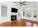 Bright living room with hardwood floors, fireplace, built-in shelving and large arched windows overlooking backyard at 1249 Waterfront Dr, Mount Pleasant, SC 29464