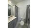 Well-lit bathroom featuring a vanity with sink, toilet, storage cabinet and glass-door shower at 1252 Allusion Ln # 201, Mount Pleasant, SC 29466