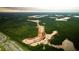Stunning aerial view of new construction development surrounded by lush green forest and water features at 127 Lilac Grove Way, Summerville, SC 29486
