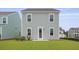 Rear view of home featuring gray siding, white trim, back door, and lawn at 127 Lilac Grove Way, Summerville, SC 29486
