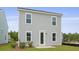 Rear view of home featuring gray siding, white trim, back door, and lawn at 127 Lilac Grove Way, Summerville, SC 29486