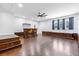 Spacious basement with a bar, hardwood floors, and a window with blue curtains at 1288 Old Colony Rd, Mount Pleasant, SC 29464