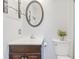 Bathroom with a dark wood vanity, white sink, and an oval mirror at 1288 Old Colony Rd, Mount Pleasant, SC 29464