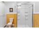 Updated bathroom featuring a glass shower enclosure, toilet and custom white cabinets at 1288 Old Colony Rd, Mount Pleasant, SC 29464