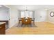 Well-lit dining room with a wooden table, six chairs, and a decorative rug at 1288 Old Colony Rd, Mount Pleasant, SC 29464