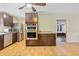 A modern kitchen with stainless steel appliances, dark cabinets, and a breakfast bar at 1288 Old Colony Rd, Mount Pleasant, SC 29464