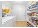 Functional laundry room with modern washer and dryer, shelving, and storage space at 1288 Old Colony Rd, Mount Pleasant, SC 29464