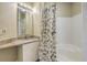 Bathroom with granite countertop, white cabinets, large mirror, and tub/shower combination at 1321 Telfair Way, Charleston, SC 29412