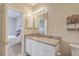Bathroom vanity with granite countertop, white cabinetry, and decorative mirror at 1321 Telfair Way, Charleston, SC 29412