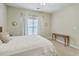 Bright bedroom features neutral walls, and carpet, with a large window dressed with white curtains at 1321 Telfair Way, Charleston, SC 29412