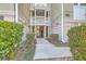 Exterior of building with walkway, greenery and the unit number shown at 1321 Telfair Way, Charleston, SC 29412