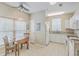 Bright kitchen with white cabinets, tile floor, breakfast table, and lots of natural light at 1321 Telfair Way, Charleston, SC 29412