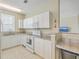 Well-lit kitchen featuring white cabinetry, granite countertops, and modern appliances at 1321 Telfair Way, Charleston, SC 29412