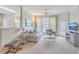 Well-lit living room with view to kitchen, large windows, and comfortable furniture at 1321 Telfair Way, Charleston, SC 29412