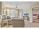 Comfortable living room with lots of light, a ceiling fan, and a view to the main bedroom at 1321 Telfair Way, Charleston, SC 29412