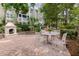 Outdoor patio features a stone fireplace and an outdoor table with chairs at 1321 Telfair Way, Charleston, SC 29412