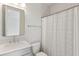 Clean, well-lit bathroom with shower curtain, sleek mirror, and neutral color palette at 1328 Upper Union Rd, Mount Pleasant, SC 29464
