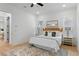 Bright bedroom with a woven headboard, neutral bedding, wood floors, and stylish bedside tables with lamps at 1328 Upper Union Rd, Mount Pleasant, SC 29464