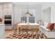 Bright breakfast nook features a built-in bench with storage, a modern pendant light, and stylish geometric rug at 1328 Upper Union Rd, Mount Pleasant, SC 29464
