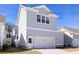 Exterior view of a home featuring a two-car garage and neutral-colored siding at 1328 Upper Union Rd, Mount Pleasant, SC 29464