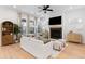 Open-concept living room with fireplace, large TV, plush seating, natural light, and hardwood flooring at 1328 Upper Union Rd, Mount Pleasant, SC 29464