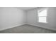 A bright bedroom features neutral carpet, white trim, and double-hung windows at 134 Lilac Grove Way, Summerville, SC 29486